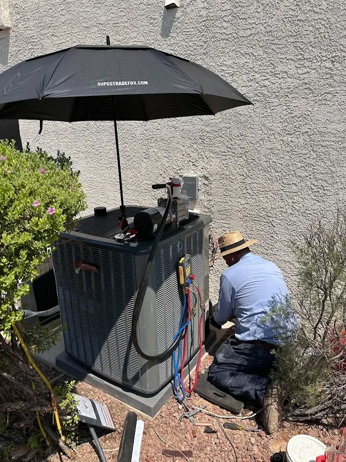 HVAC technician performing outdoor AC maintenance in Fort Worth